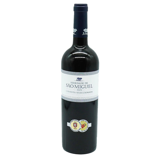 A bottle of Herdade Sao Miguel Tinto wine with a white label and decorative elements on the label, typical of a premium Portuguese wine.